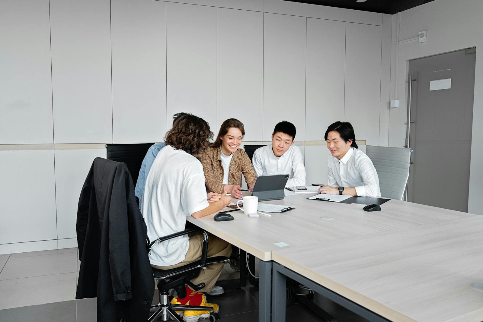 Business team reviewing financial data and comparing options in a meeting
