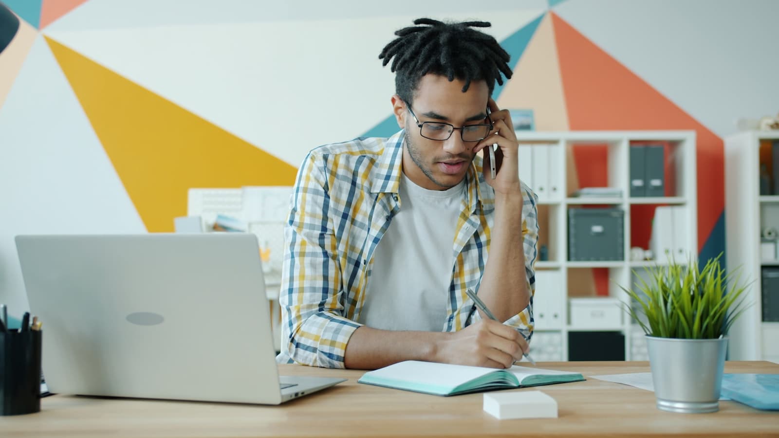 Professional on a phone call at a desk with documents in front of them